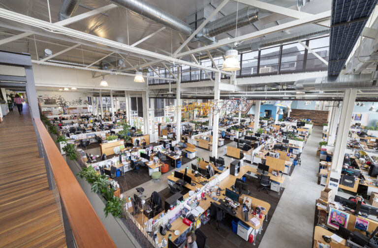 Spacious open office with numerous desks.