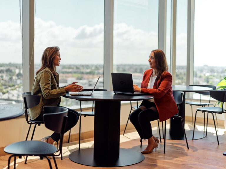 Two women working in modern office.