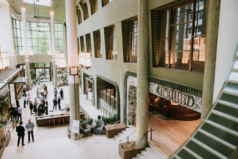 Modern lobby with people socializing.