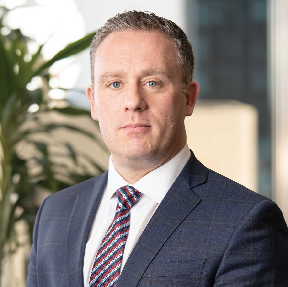 Man in suit with plants background